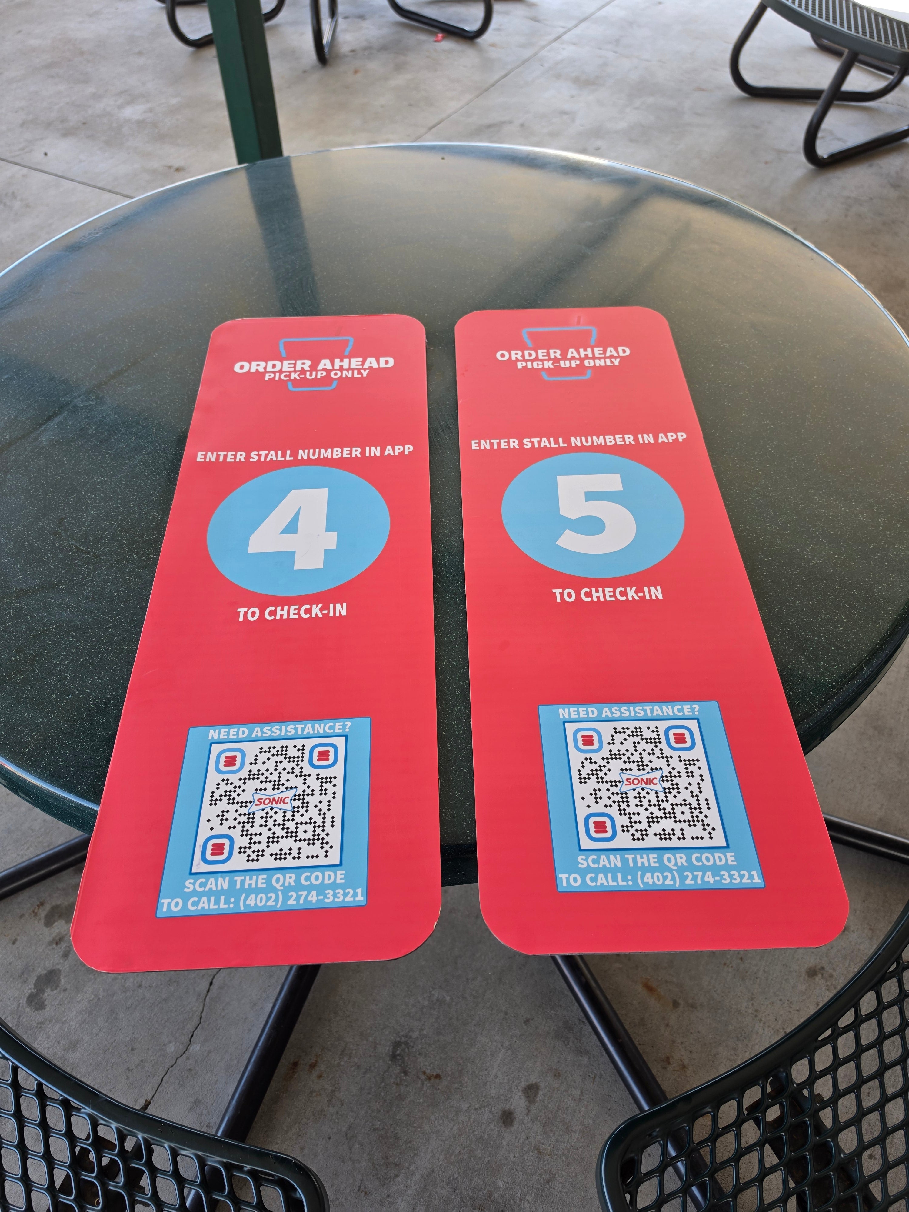 Order-ahead stall signs — finished, close-up